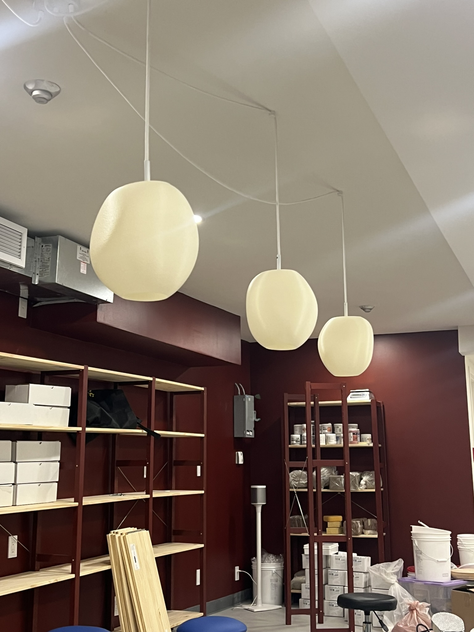 Three Cobble Pendants at staggered heights in a studio workspace